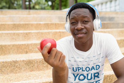 T-Shirt Mockup of a Man Eating an Apple While Listening to Music 40354-r-el2
