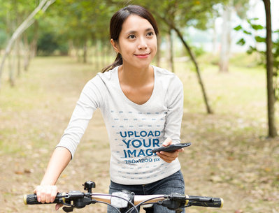 Long-Sleeve Tee Mockup Featuring a Woman With a Bike 