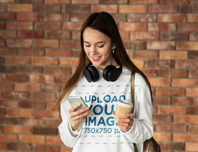 Pullover Hoodie Mockup of a Woman with Headphones Checking Her Cellphone m8810 r-el2