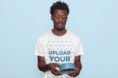 T-Shirt Mockup of a Man with a Surprised Face at a Studio