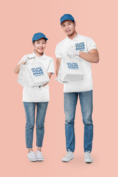 Mockup of Two Workers in Polo Shirts Holding Paper Bags m29099 r-el2