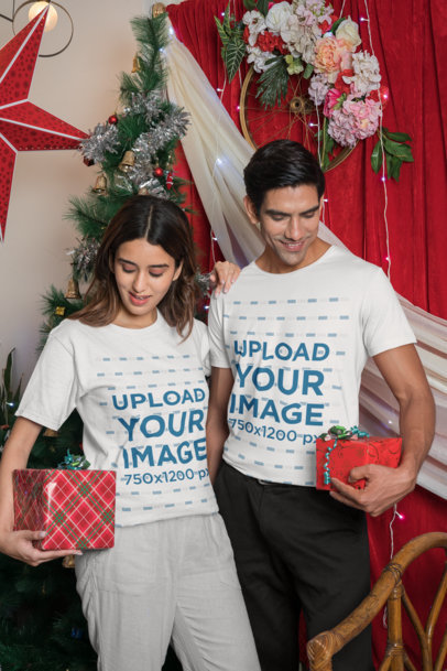 T-Shirt Mockup of a Couple Holding Christmas Gifts m30614