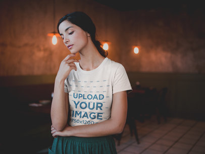 Mockup of a Beautiful Woman Wearing a T-Shirt at a Restaurant