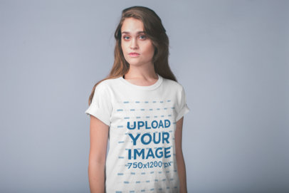Woman Wearing a T-Shirt Mockup Standing Against a White Background