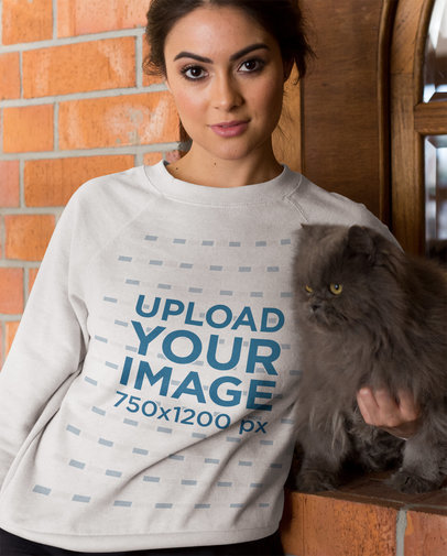 Portrait of a Woman Wearing a Crewneck Sweatshirt Mockup Holding her Cat a18785