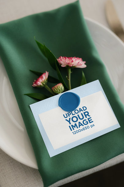 Mockup of a Wedding Program Placed on a Cloth Napkin With Flowers m33999 r-el2