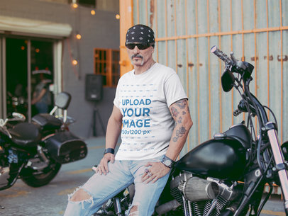 T Shirt Mockup Featuring a Tattooed Middle Aged Biker Leaning on a Motorcycle Outside a Bar 20242