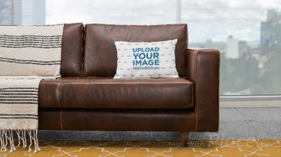Parallax Video Mockup Featuring a Pillow on a Leather Couch
