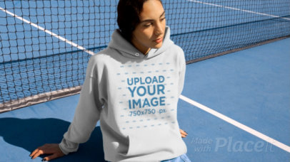 Hoodie Video Featuring a Woman Sitting in a Tennis Court 13210