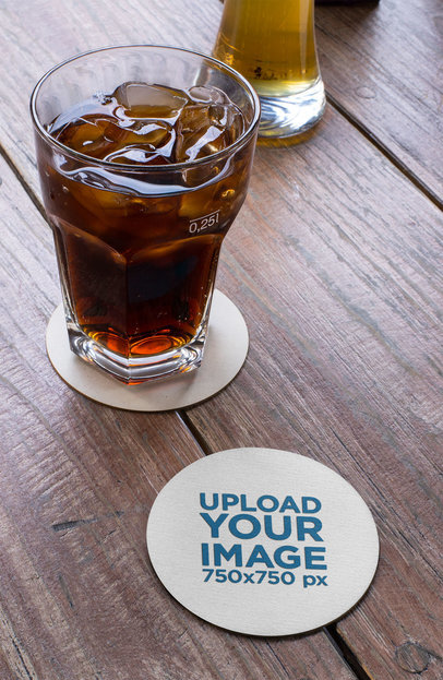 Mockup of a Round Coaster by a Cola Drink over a Wooden Table 27809