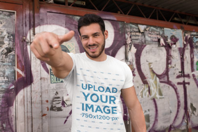 T-Shirt Mockup of a Fitness Man Pointing at the Camera 