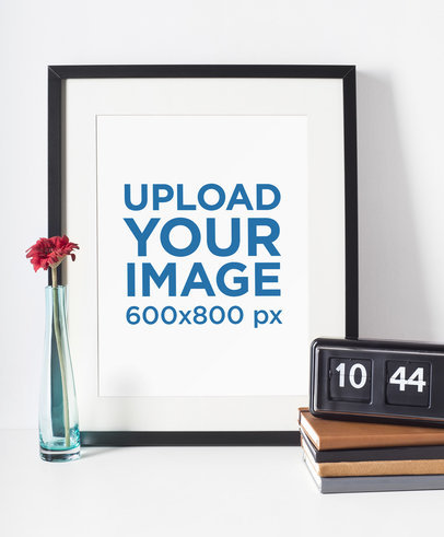 Picture Frame Mockup Standing Next to a Flower Vase and a Retro Alarm Clock 603-el