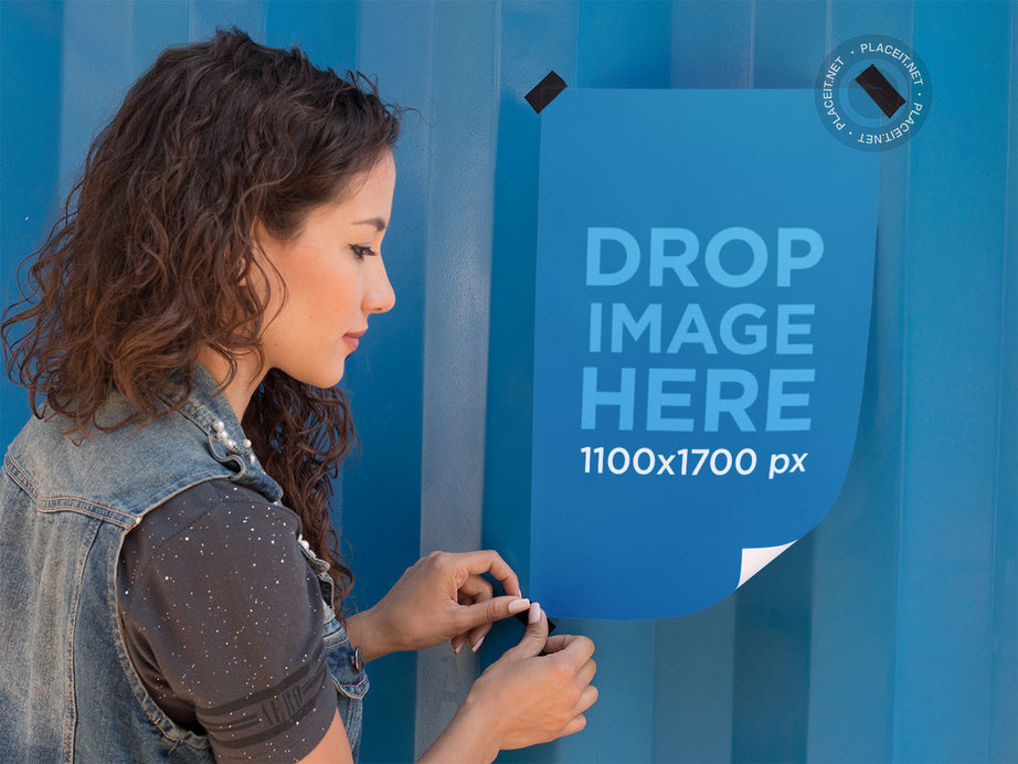 Placeit Mockup Template of a Woman Taping a Poster to a Wall