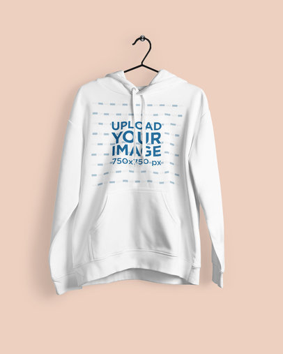 Mockup of a Pullover Hoodie Hanging on a Plain Background 
