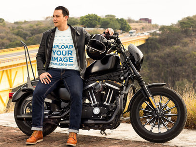 T-Shirt Mockup Featuring a Biker Standing Next to His Motorcycle