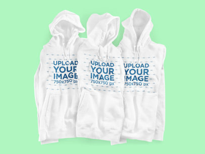 Mockup of Three Hoodies Placed on a Customizable Surface 3590-el1