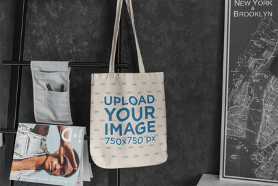 Mockup Featuring a Sublimated Tote Bag Hanging From a Dar Metal Rack 3143-el1