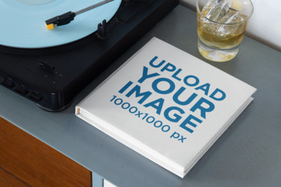 Mockup of a Squared Book Next to a Record Player 33907
