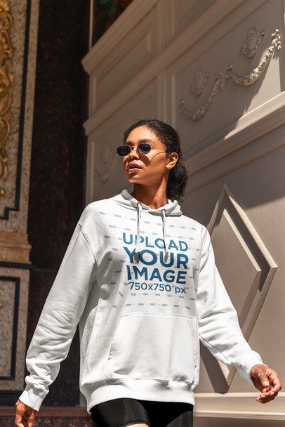 Pullover Hoodie Mockup of a Young Woman Walking by an Elegant Building 4854-el1