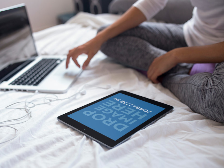 Placeit Mockup of an iPad in Portrait Position Lying on a Bed