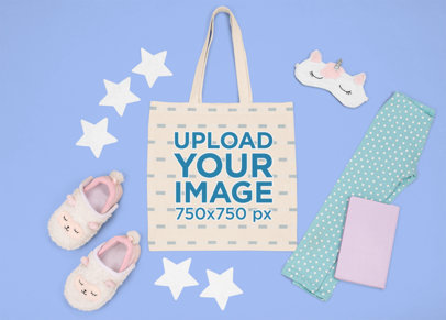 Mockup of a Flat Laid Tote Bag Featuring a Kid's Sleeping Outfit m1270
