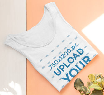 Mockup of a Folded Tank Top Lying by Some Plants 33965a